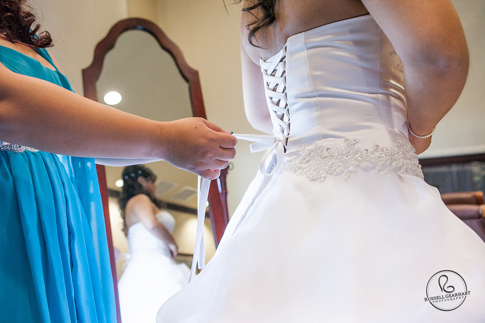 Tying Bride into Wedding Dress - Wedding at Black Gold Golf Club – Russell Gearhart Photography – www.gearhartphoto.com
