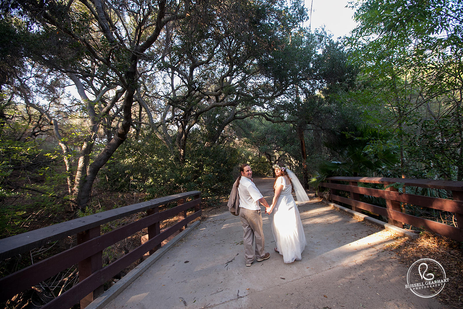 Wedding Couple Crossing Bridge – Oak Canyon Nature Center Wedding: Orange County, CA – Russell Gearhart Photography – www.gearhartphoto.com  