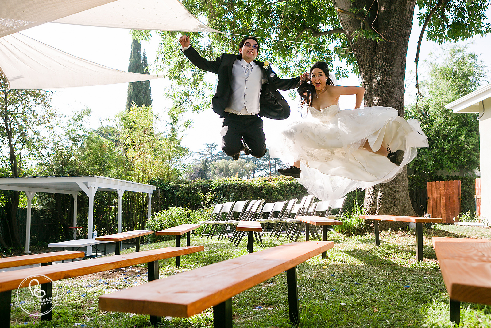 Bride and Groom Jump Around After the Ceremony – Pasadena Backyard Wedding – Russell Gearhart Photography – www.gearhartphoto.com