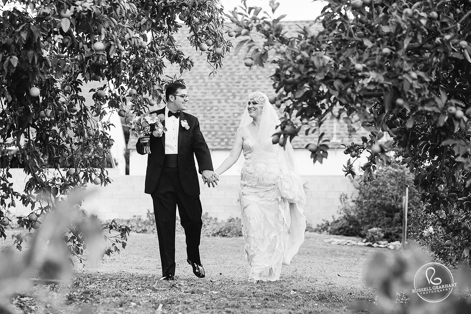 Bride and Groom Stroll Through the Orange Grove - Backyard Whittier Wedding – Russell Gearhart Photography – www.gearhartphoto.com