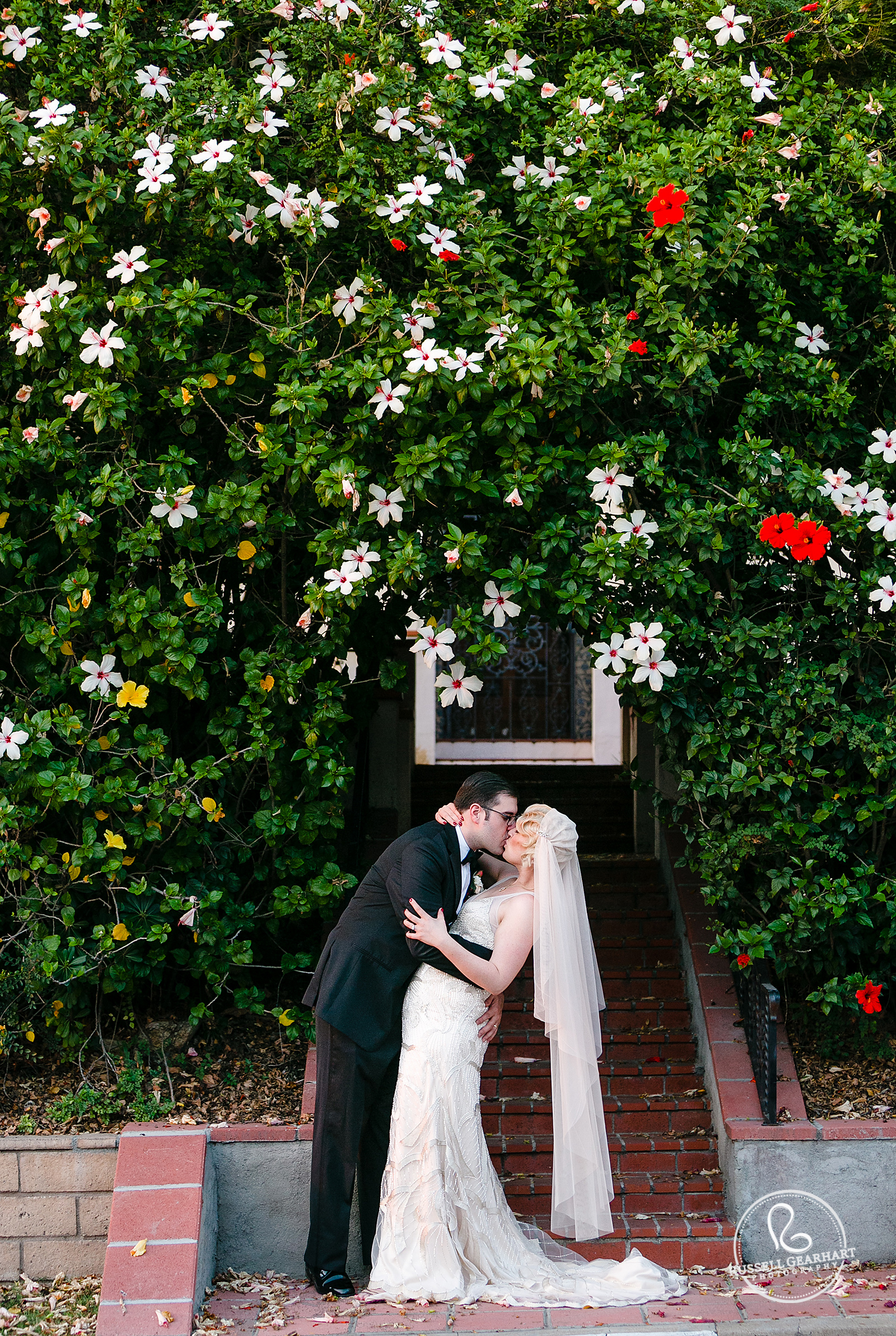 Bridal Portrait on Steps Surrounded by Hibiscus - Roaring Twenties Wedding – Russell Gearhart Photography – www.gearhartphoto.com