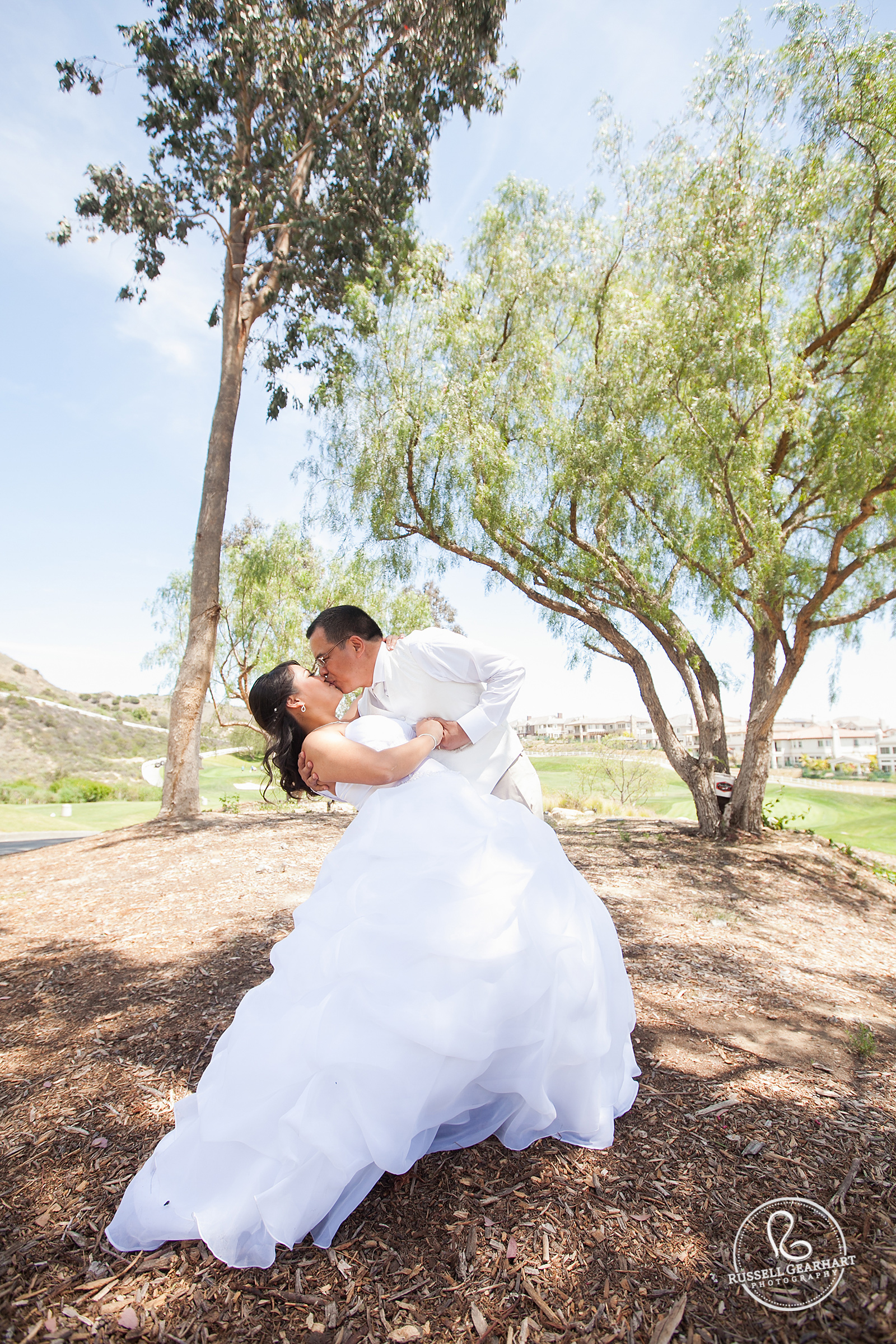 Groom Dipping the Bride on Golf Course - Outdoor Yorba Linda Wedding – Russell Gearhart Photography – www.gearhartphoto.com